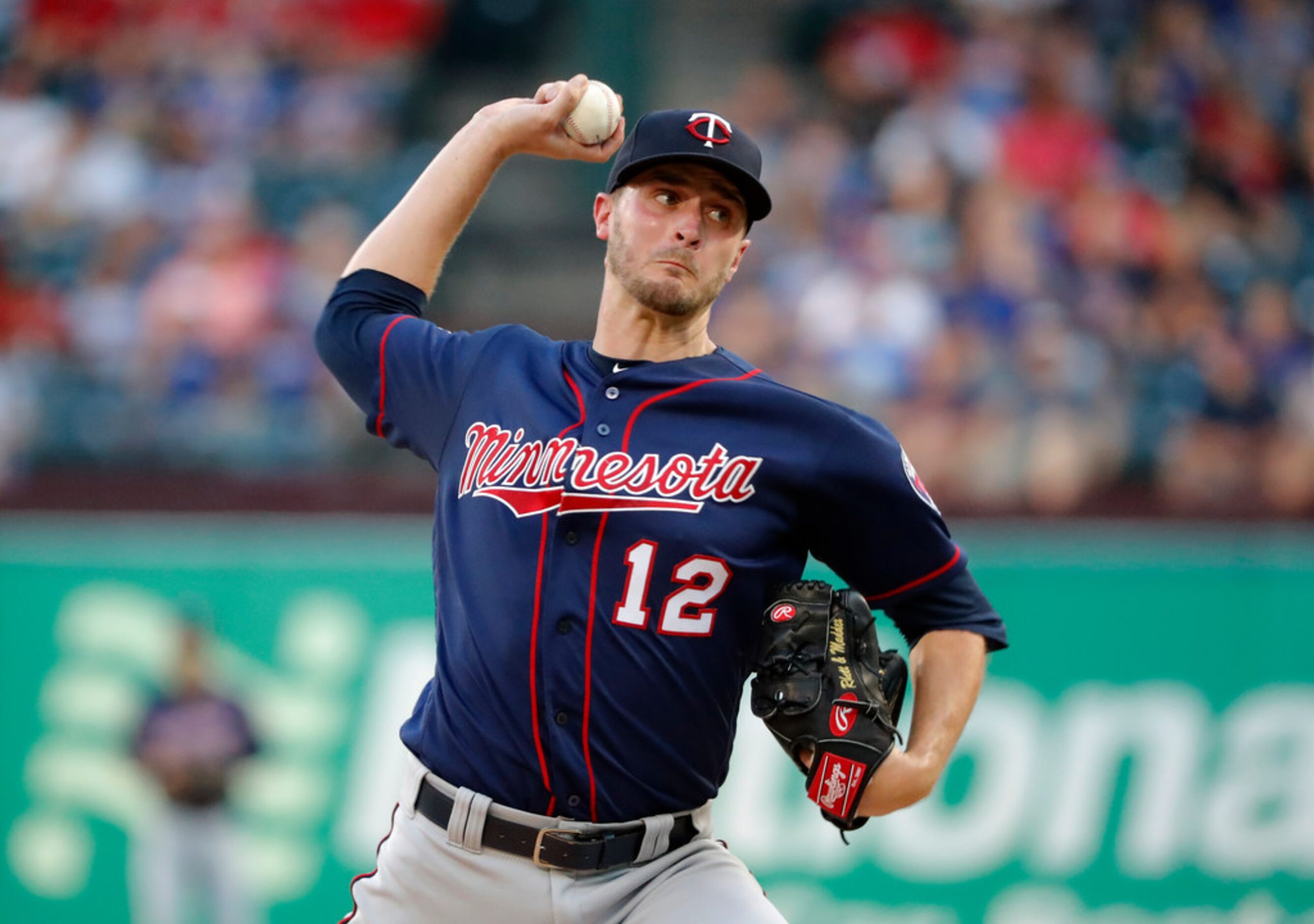 Minnesota Twins starting pitcher Jake Odorizzi throws to a Texas Rangers batter during the...