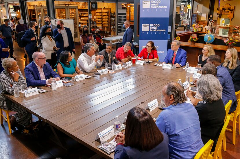 Gov. Greg Abbott listens as small business owners describe how a labor shortage is limiting...