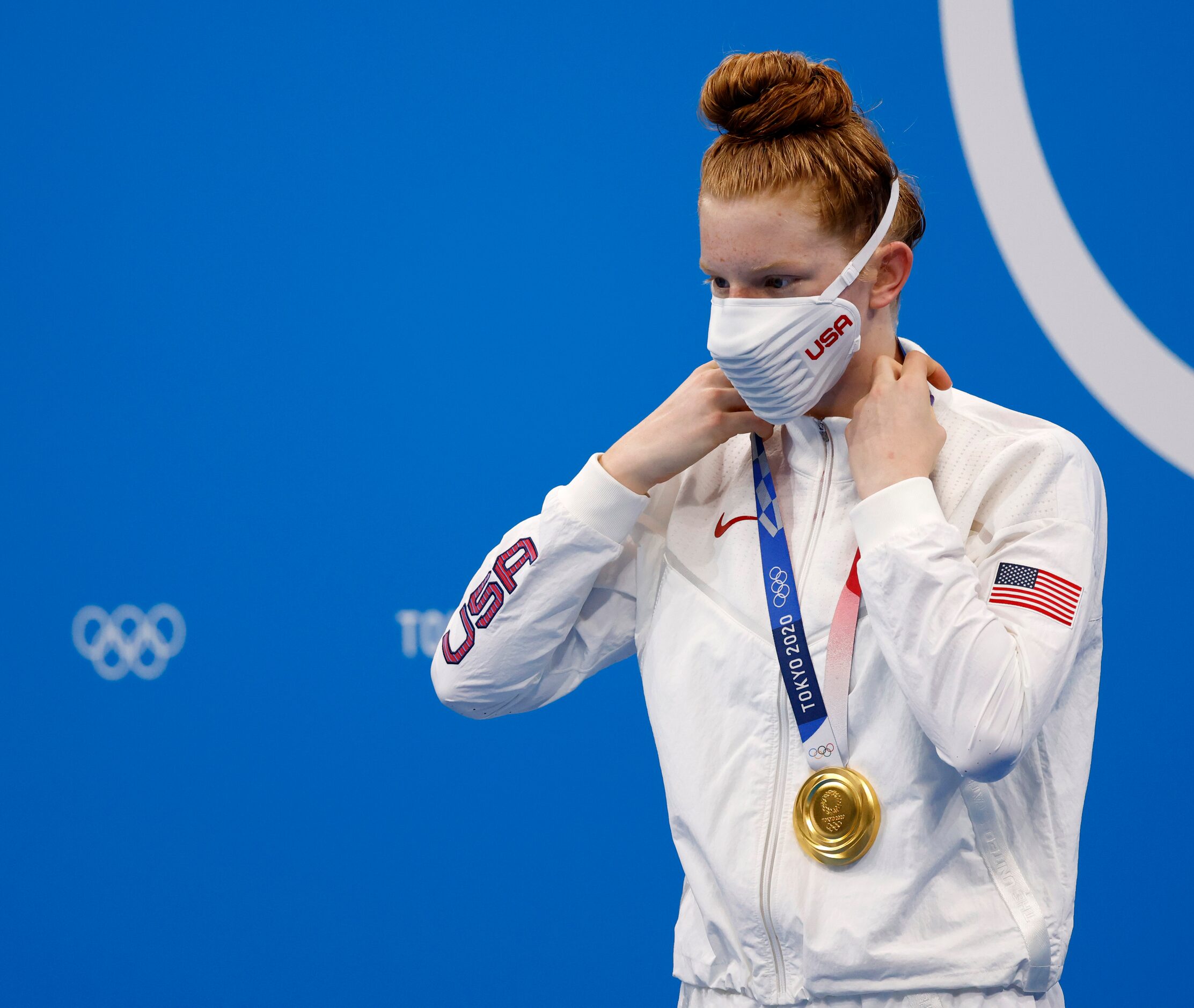 USA’s Lydia Jacoby puts on her gold medal during the medal ceremony for the women’s 100...