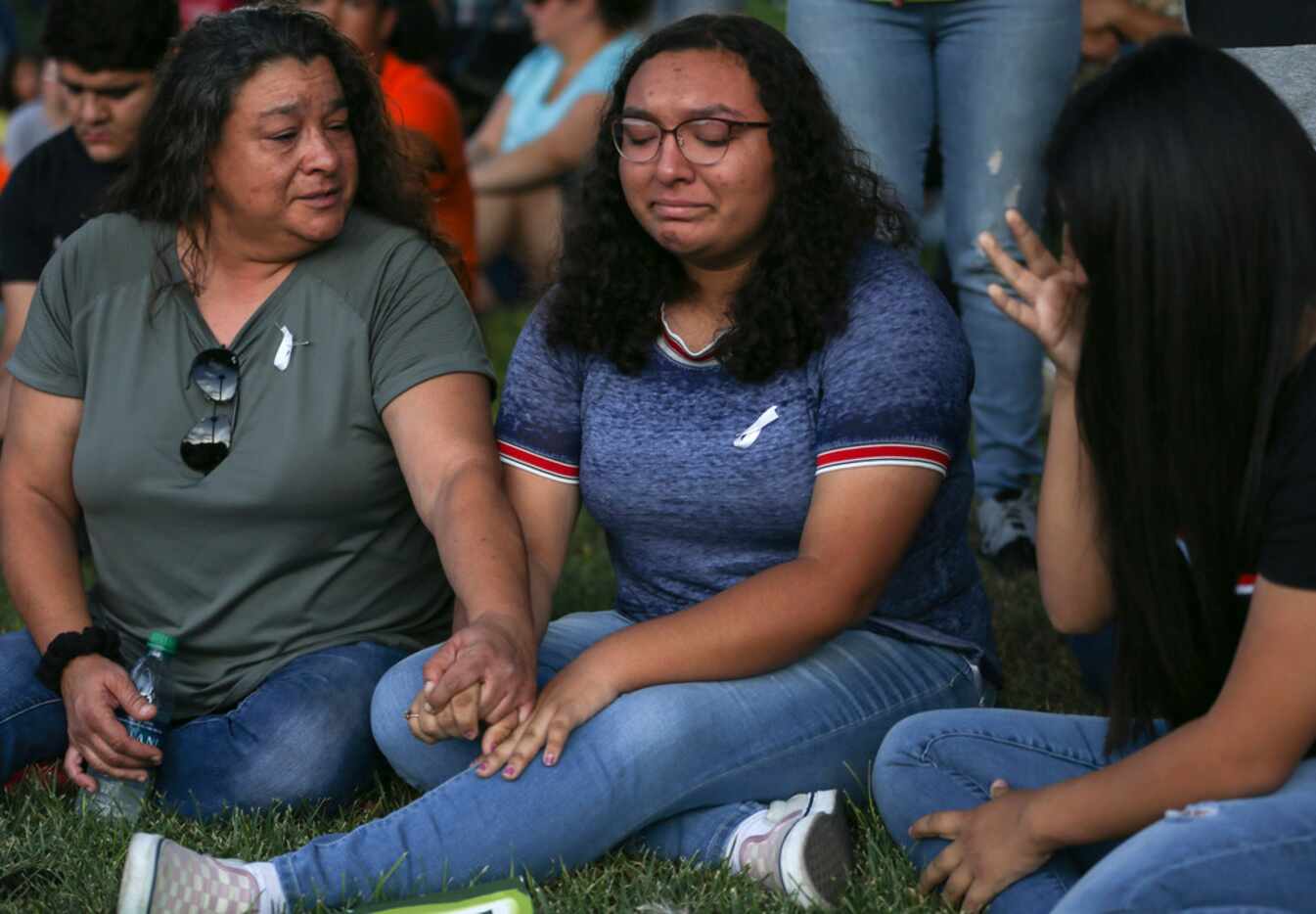 Christina Lopez (from left) comforts her daughter, Celia Lopez, 15, and Sajeili Carrasco,...