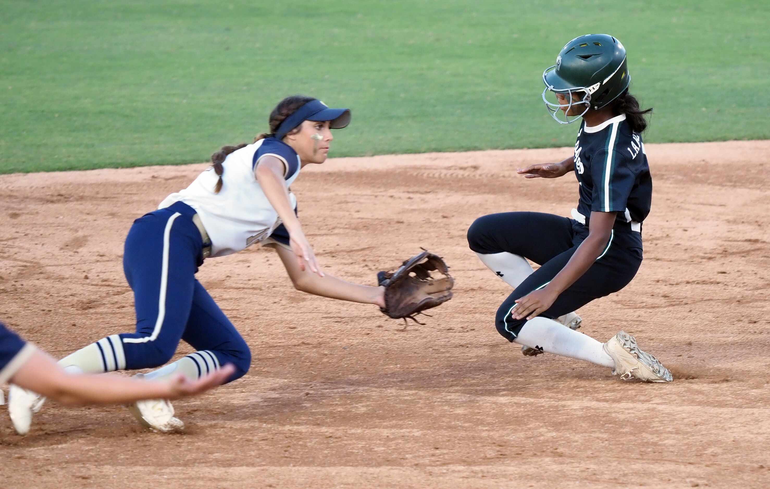 Mansfield Lake Ridge baserunner Paris Johnson (right) slides safely into second past...