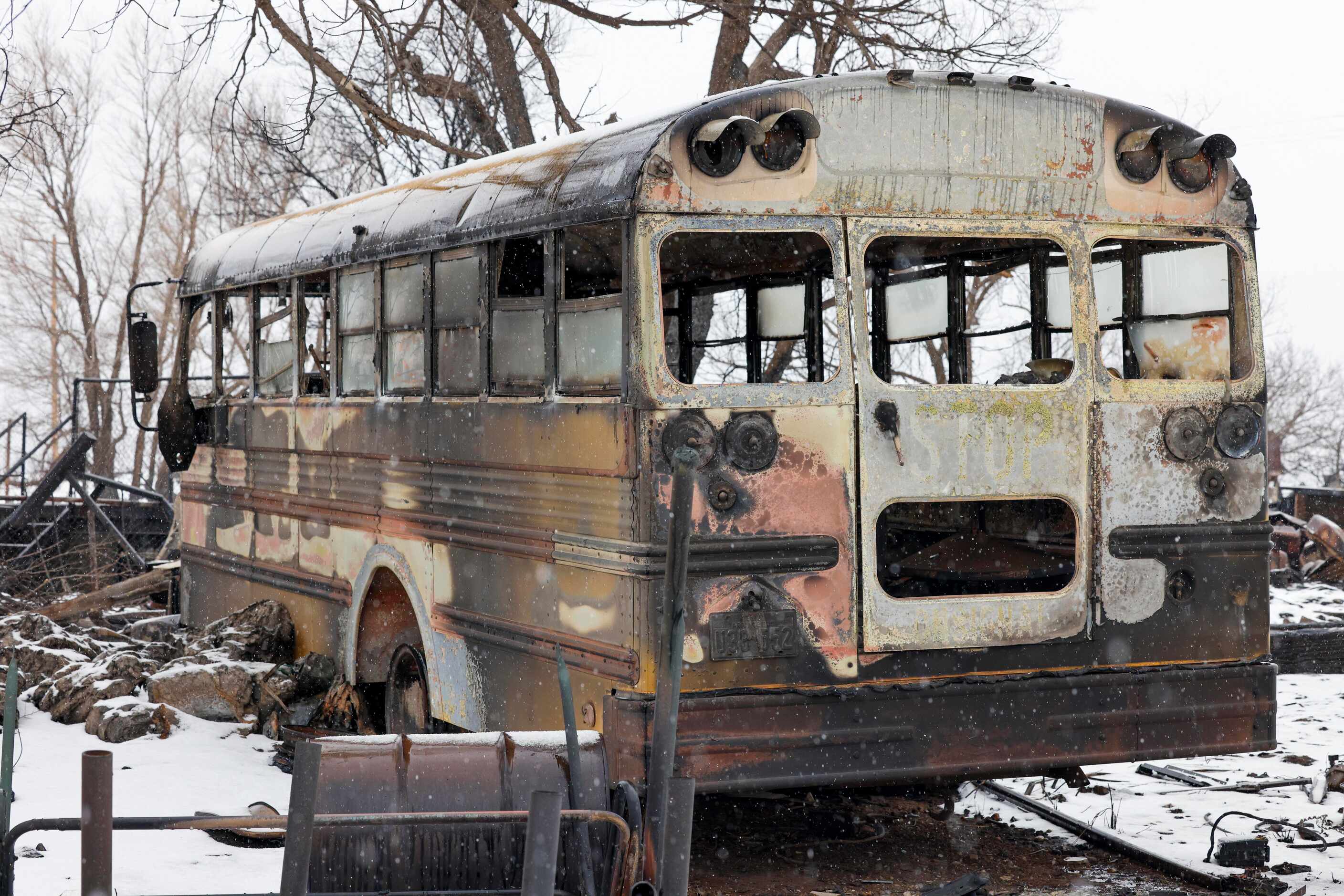 A charred school bus sits on a lot burned by the Smokehouse Creek Fire, Thursday, Feb. 29,...
