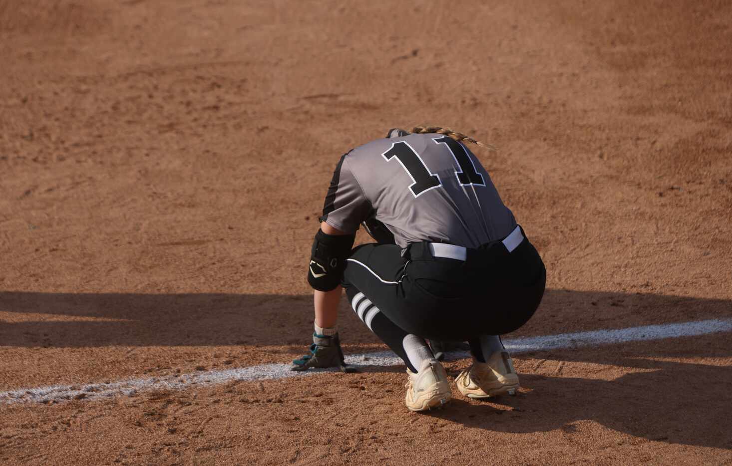 Denton Guyer's Paige Luzader (11) reacts after being retired as the final out in the team's...