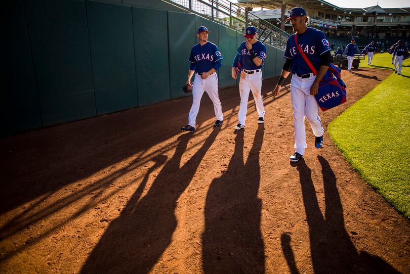 04:33 PM -- Robinson (center) walks off the field with pitcher Nick Gardewine (left) and...