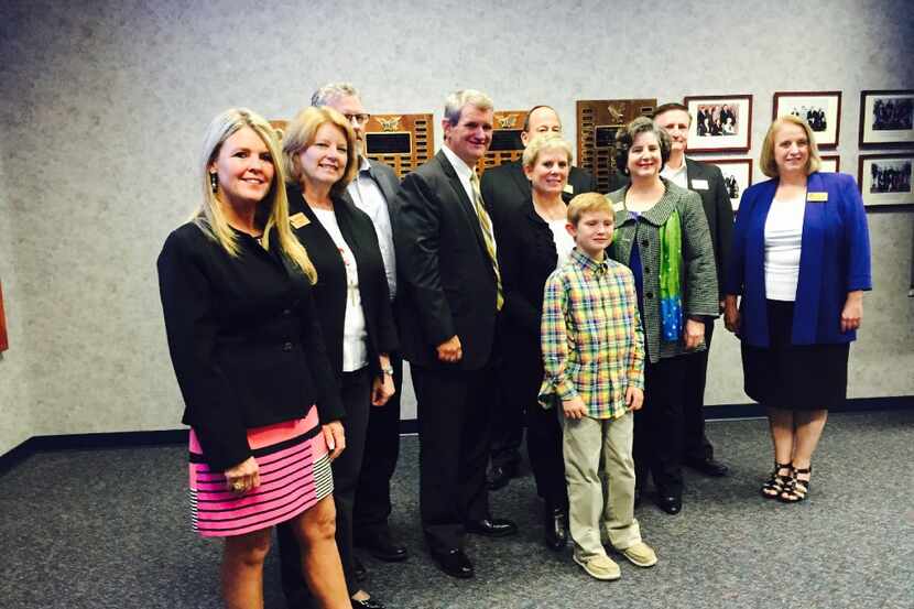 Allen ISD board of trustees stand with Scott Niven, current superintendent of Red Oak ISD,...