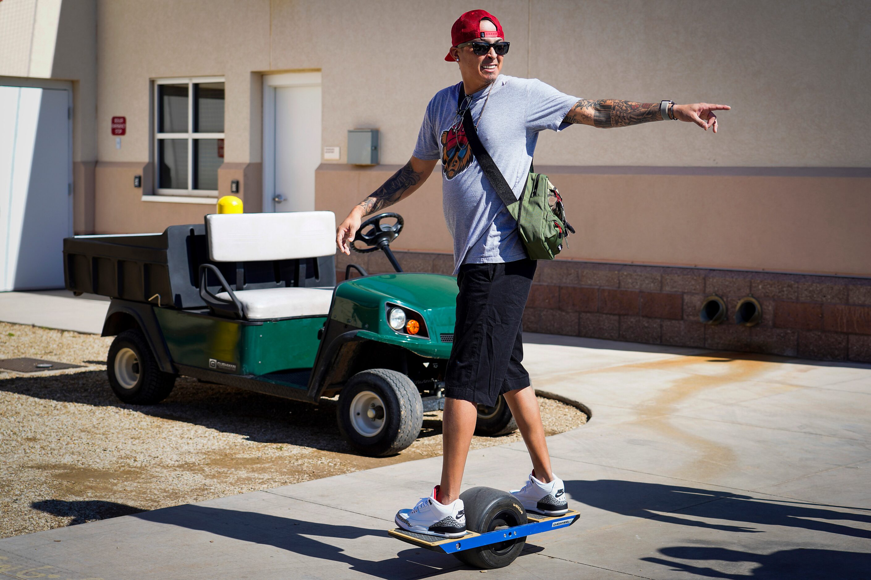 Texas Rangers pitcher Jesse Chavez rides a Onewheel from the clubhouse to the parking lot...