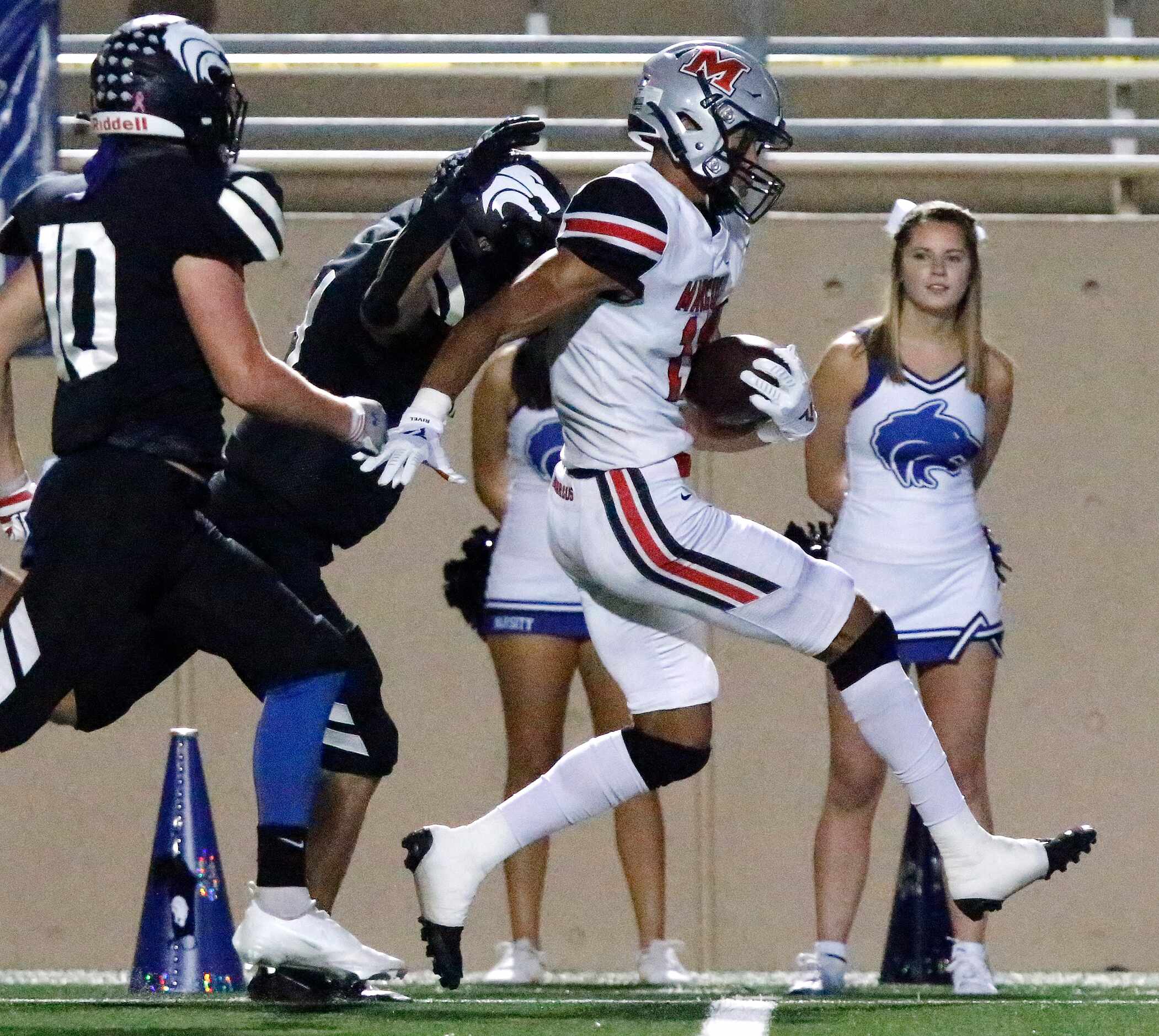 Flower Mound Marcus High School wide receiver Dallas Dudley (11) is chased down by Plano...