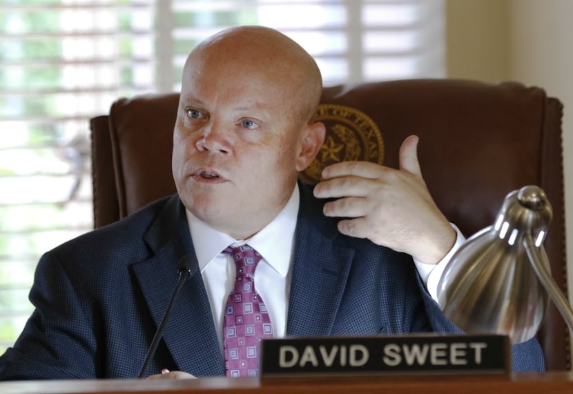 Rockwall County Judge David Sweet presides over a county court meeting at the Historic...