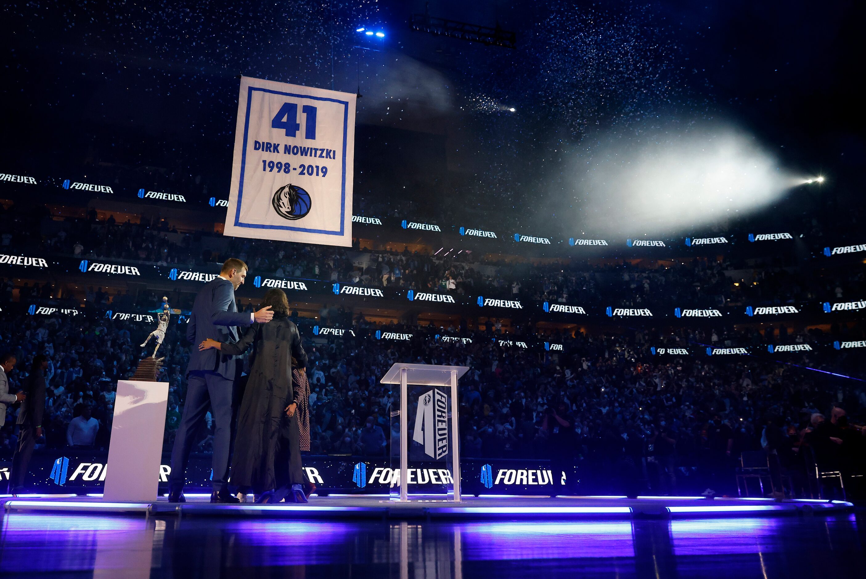 Former Dallas Mavericks All-Star Dirk Nowitzki and his family watch as his jersey is lifted...