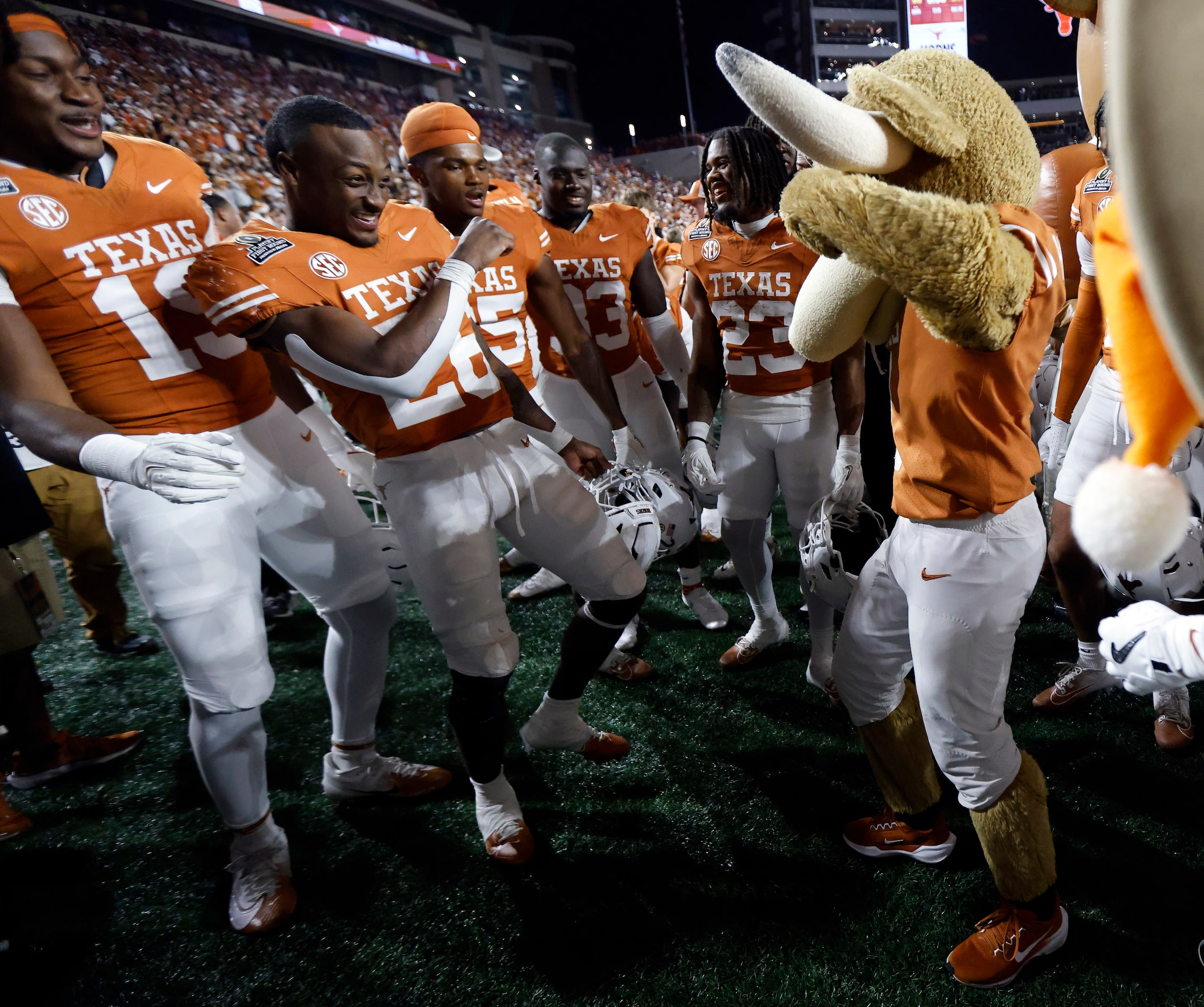 Texas Longhorns running back Quintrevion Wisner (26) dance with Hook’em the mascot following...