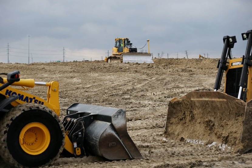 Construction continues during the groundbreaking ceremony Tuesday for McKinney ISD Stadium...