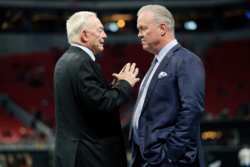 Dallas Cowboys owner Jerry Jones (left) visits with his son Stephen Jones before their game...