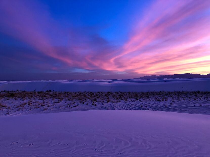 A sunset at White Sands National Park paints the dunes in a striking lavender hue.