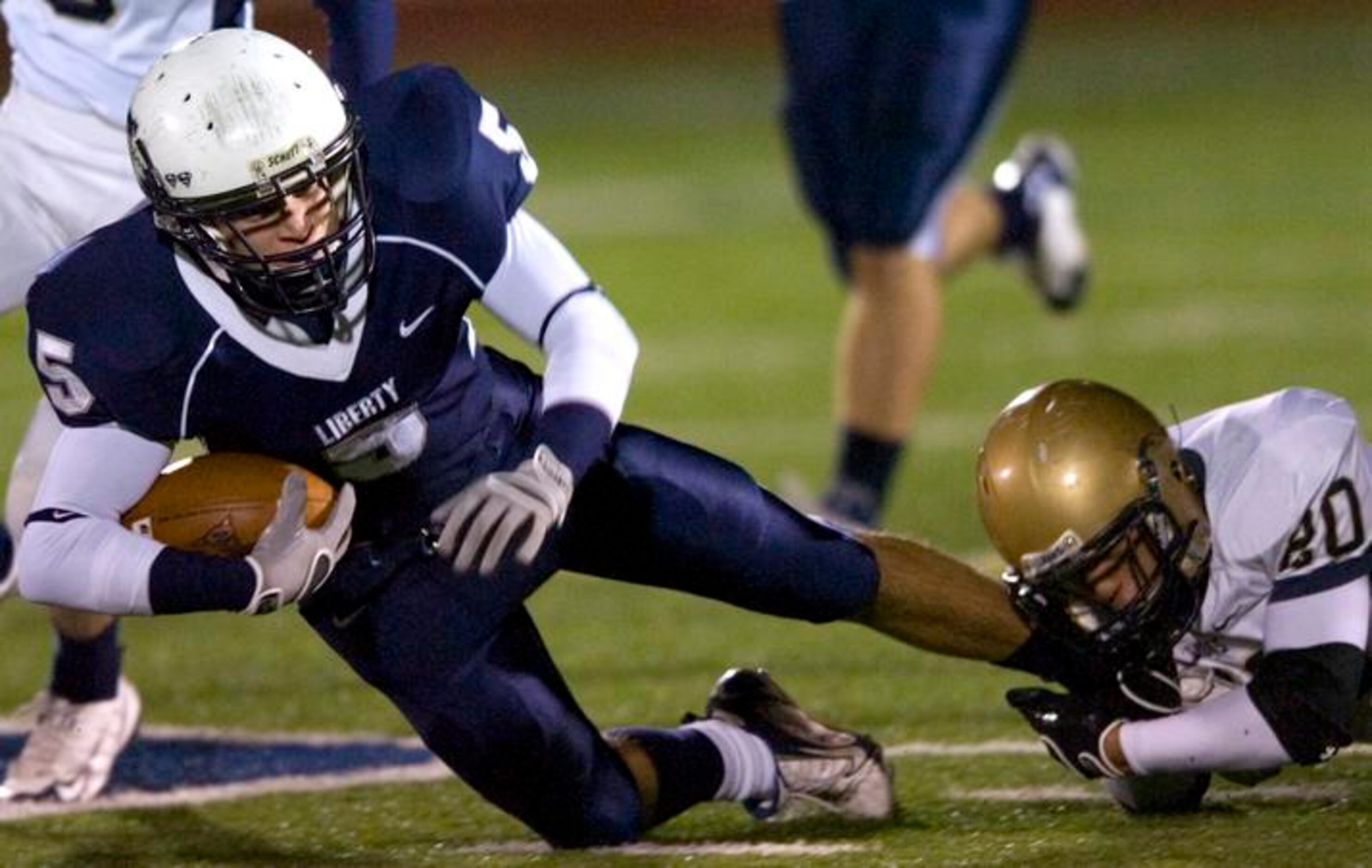 Argyle Liberty Christian sophomore wide receiver Jake Lawson (5) is tackled by Arlington...