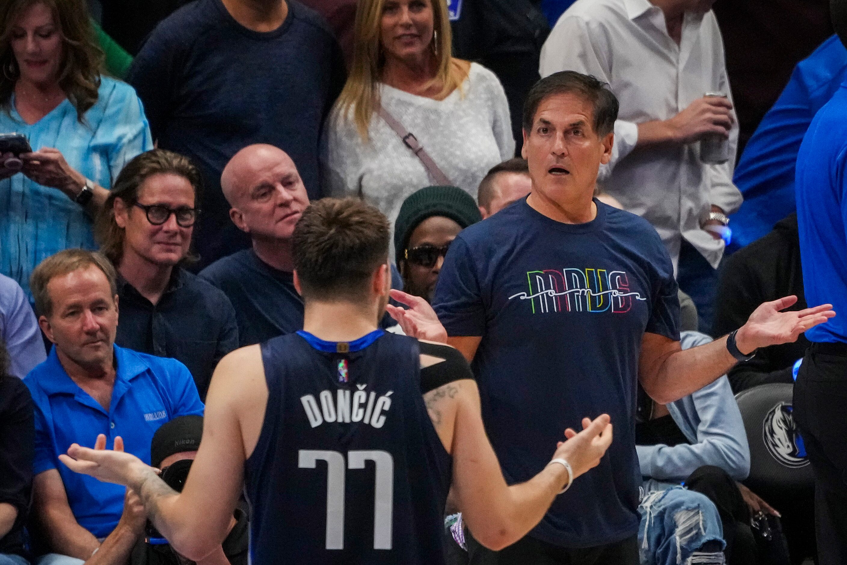 Dallas Mavericks guard Luka Doncic  and owner Mark Cuban react after an offensive foul call...