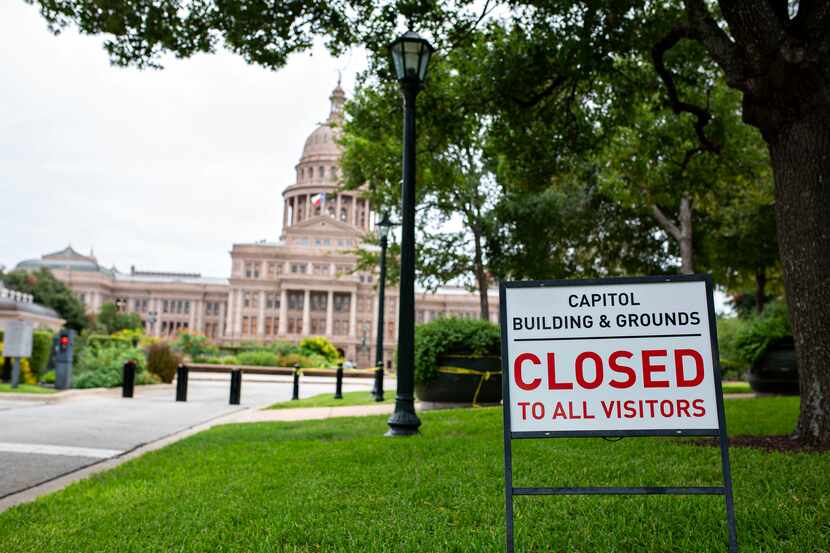 Yellow police tape and closed signs dot the grounds of the Texas Capitol in Austin, still...