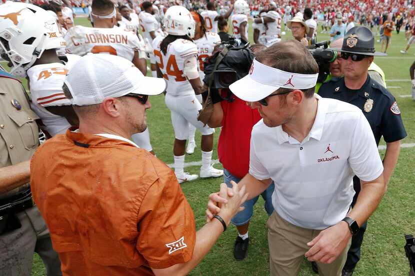 Texas head coach Tom Herman, left, and Oklahoma head coach Lincoln Riley greet each other...