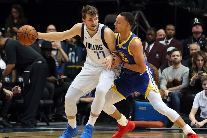 Dallas Mavericks guard Luka Doncic (77) tries to make an opening against Golden State...