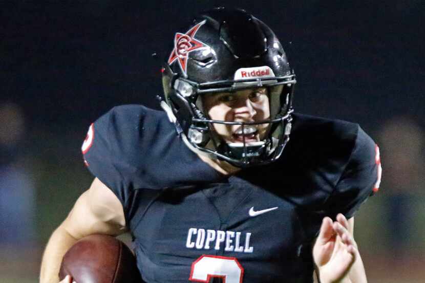 Coppel High School quarterback Brady Mcbride (2) keeps the football for a gain during the...