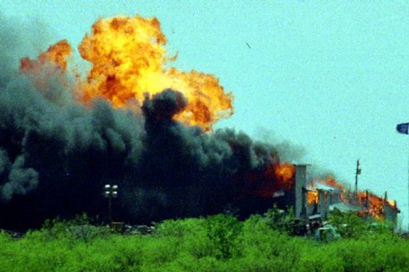 The Branch Davidian compound is rocked by an explosion after the Davidians set fire to it in...