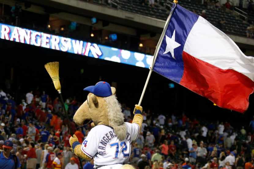  Rangers Captain, the baseball team's mascot, pulls out the broom Wednesday night after...