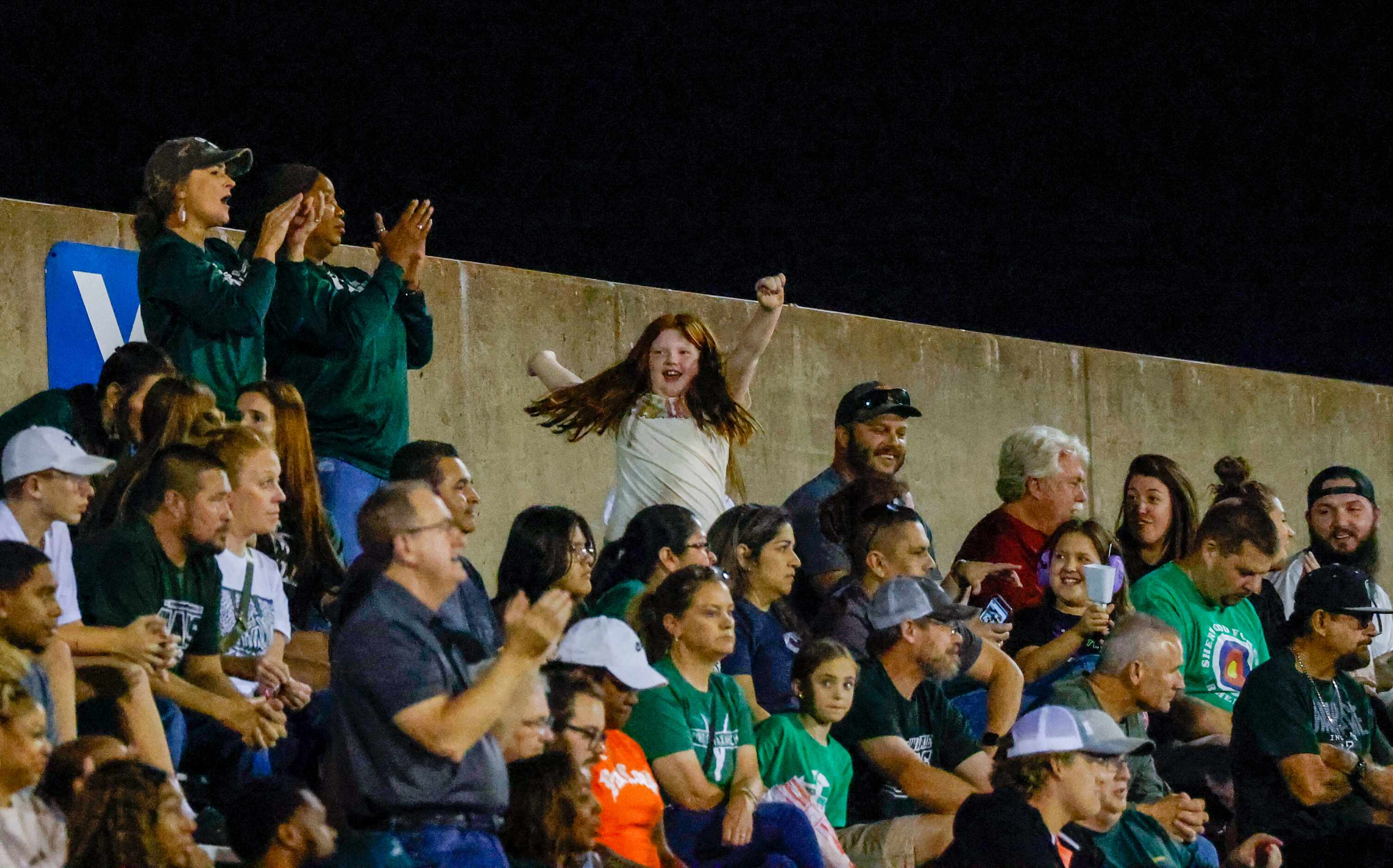 A Waxahachie fan spins with their arms in the air as the team plays Duncanville at Panther...