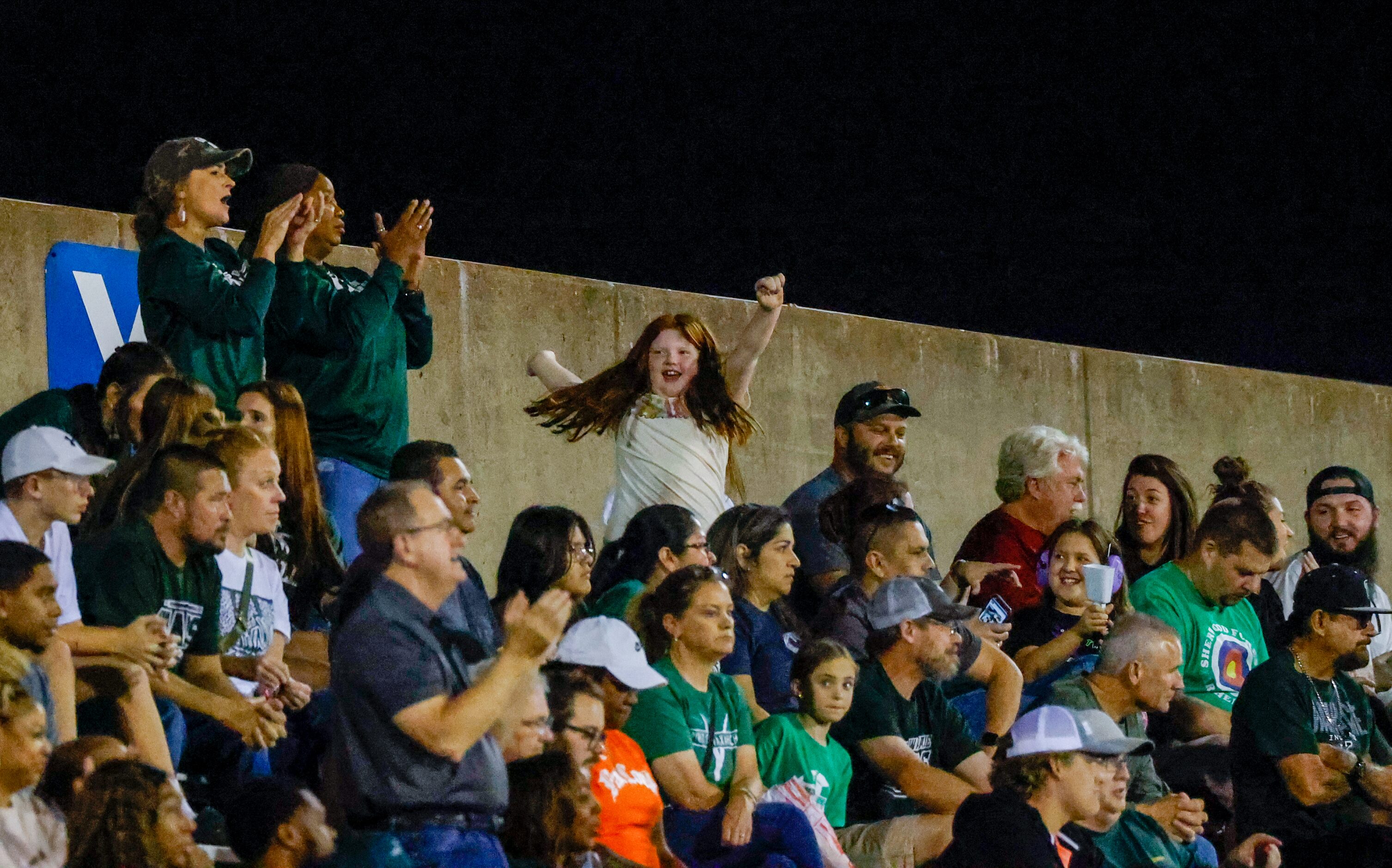 A Waxahachie fan spins with their arms in the air as the team plays Duncanville at Panther...