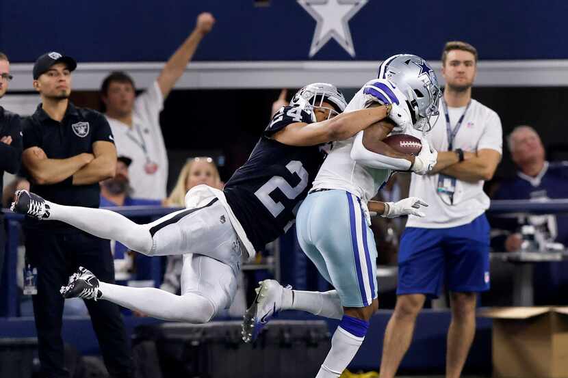 Dallas Cowboys wide receiver Cedrick Wilson (1) carries Las Vegas Raiders safety Johnathan...
