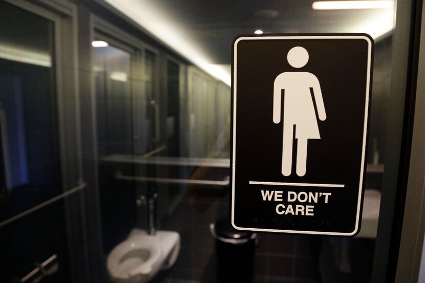 FILE - A sign outside a restroom at 21c Museum Hotel in Durham, N.C., where a "bathroom...