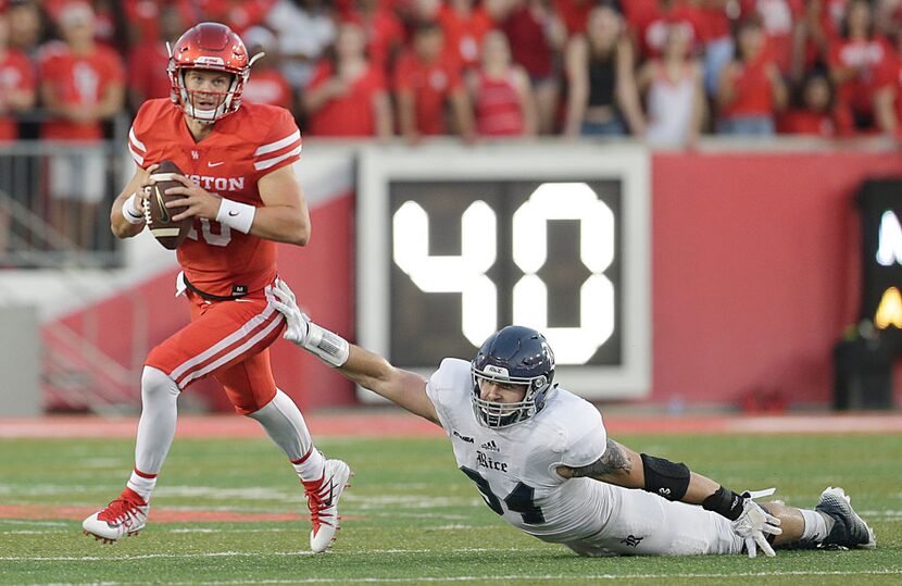 HOUSTON, TX - SEPTEMBER 16: Kyle Allen #10 of the Houston Cougars escapes the graspse of...