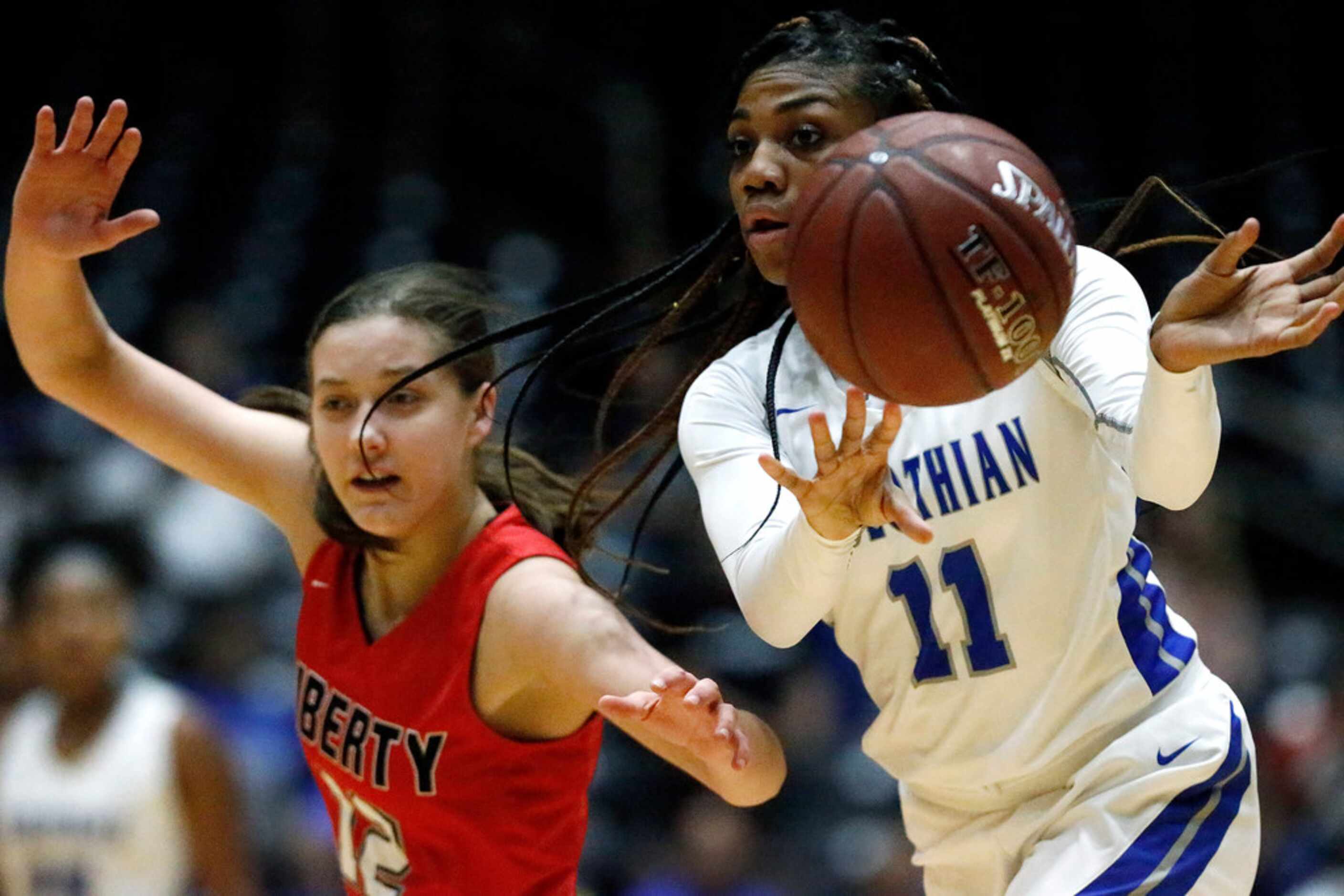 Midlothian High School guard Maykayla Jackson (11) passes the ball in overtime while Frisco...