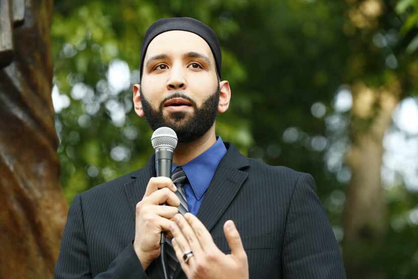 In this file photo, Imam Omar Suleiman speaks at a candlelight vigil for the victims and...