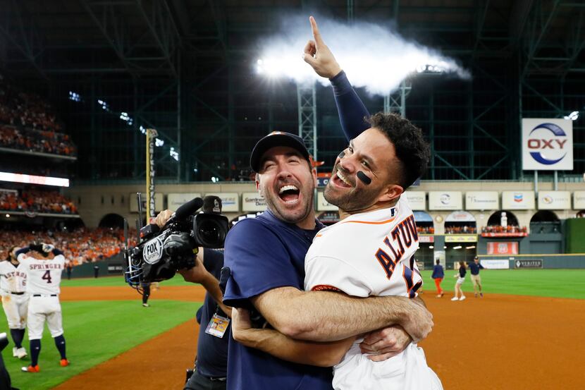Houston Astros' Jose Altuve, right, and starting pitcher Justin Verlander celebrate after...