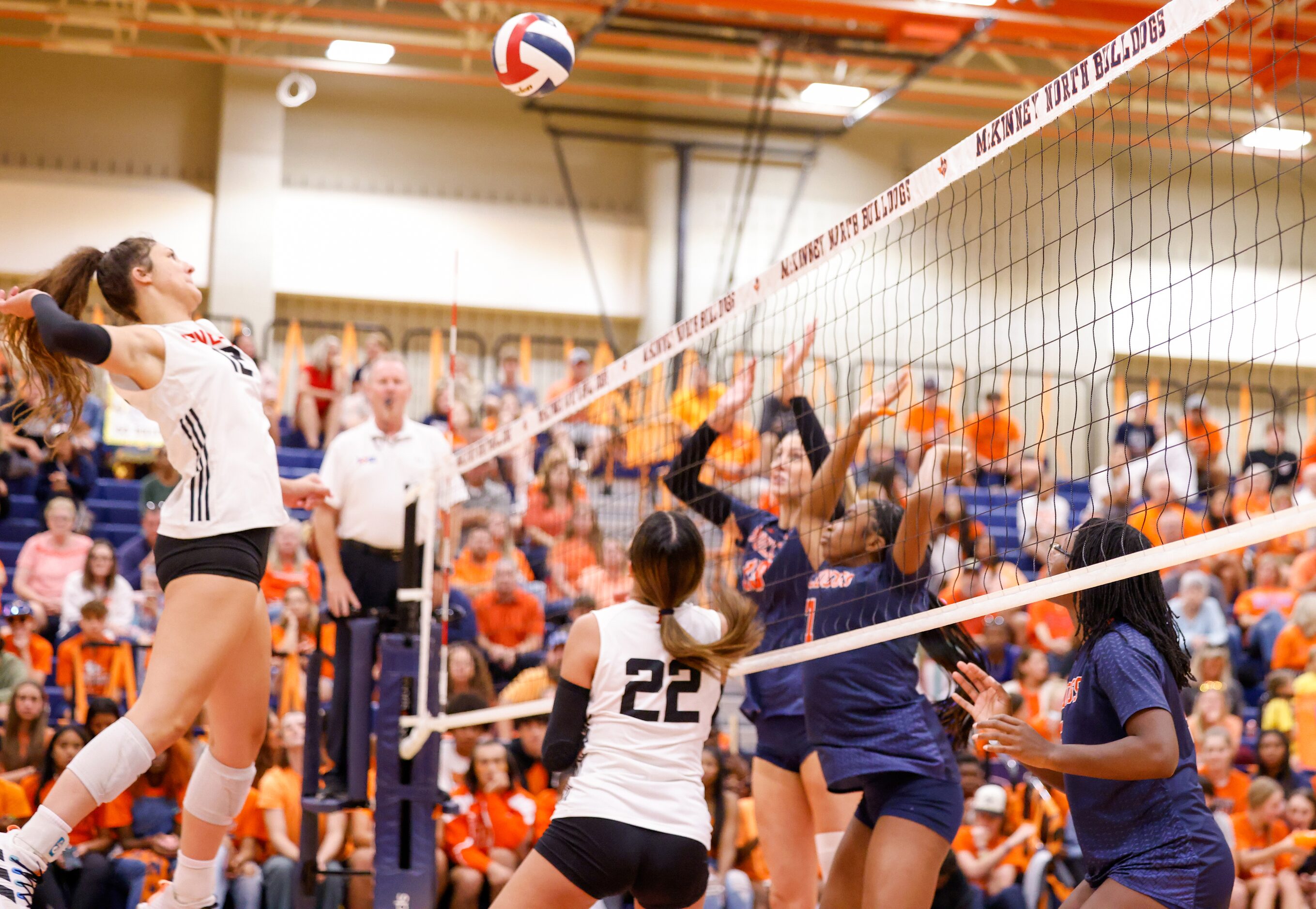 Lovejoy Hannah Gonzalez (12) jumps to spike the ball past McKinney North defenders at a...