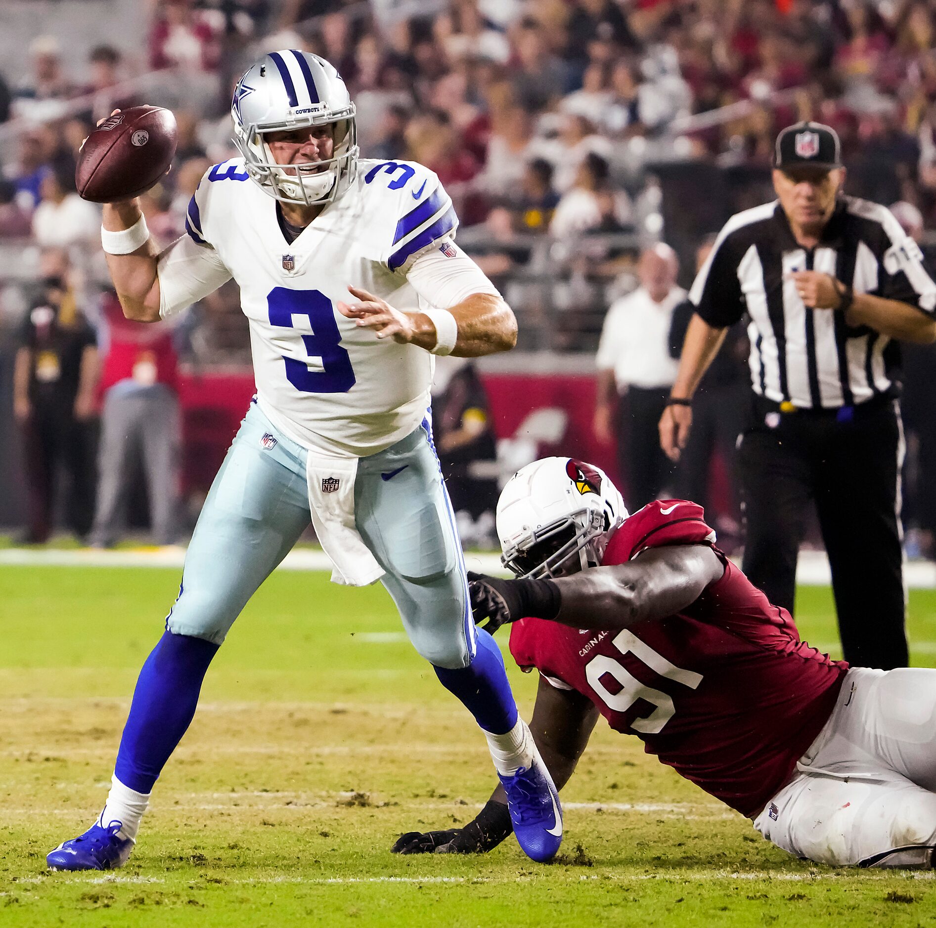 Dallas Cowboys quarterback Garrett Gilbert (3) scrambles away from Arizona Cardinals...