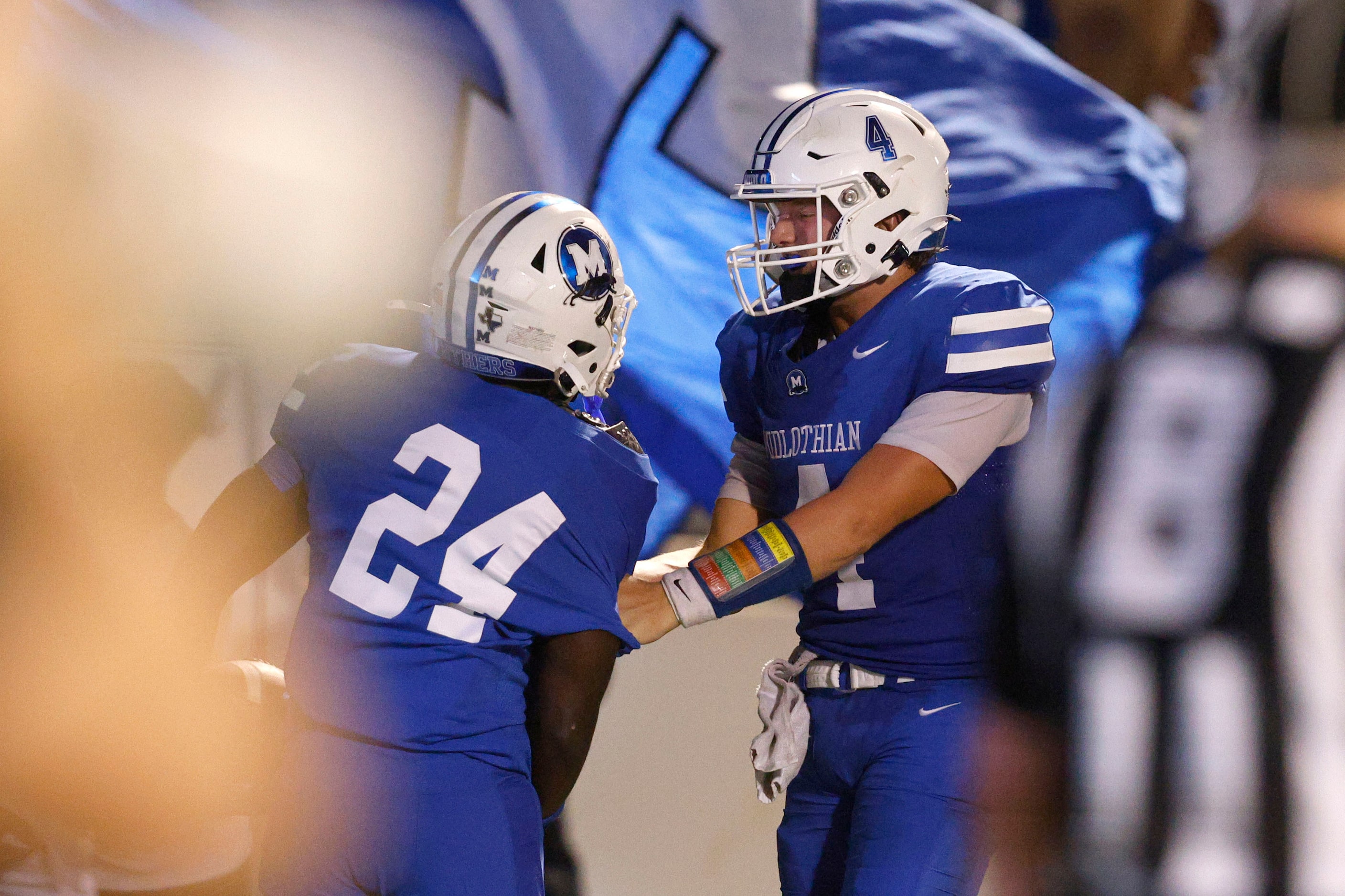 Midlothian's Michael Archie (24) celebrates with Midlothian's Beau Wendel (4) after scoring...