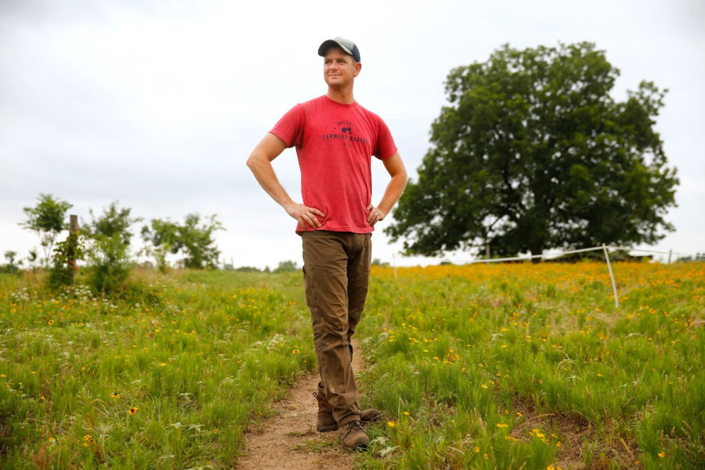Farmer Thomas Locke walks the third-generation,160-acre  Bois d'Arc farm farm he and his...