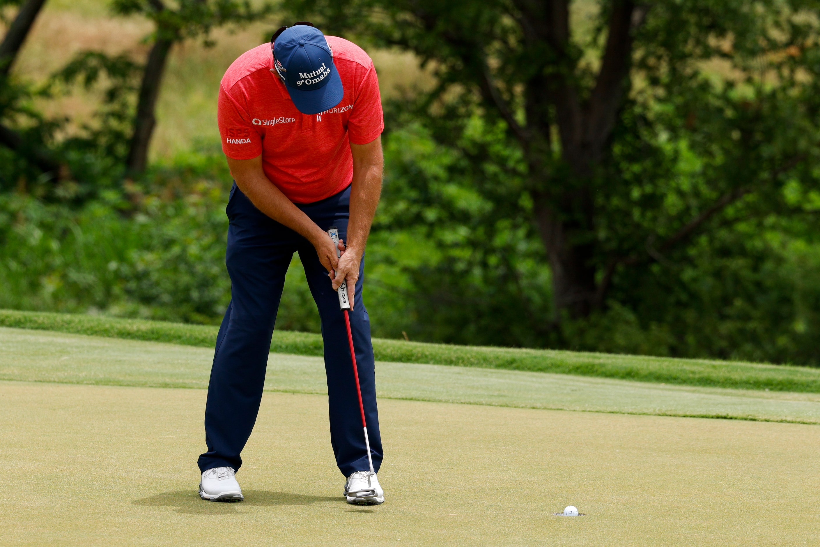 Padraig Harrington of Ireland sinks a putt for birdie on the 18th hole during the first...