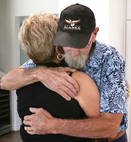 Shannon Dion gets a hug from Dan Probst after a news conference held by some of the families...