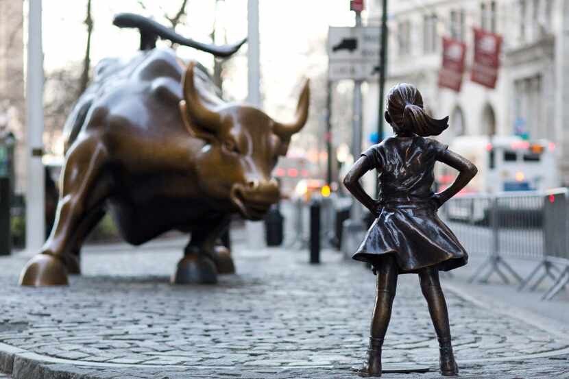 In this March 22, 2017 photo, the Charging Bull and Fearless Girl statues are sit on Lower...
