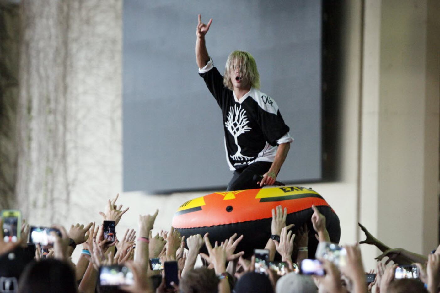 Lead singer Devin Oliver of the band I See Stars uses an inflatable raft to crowd surf...