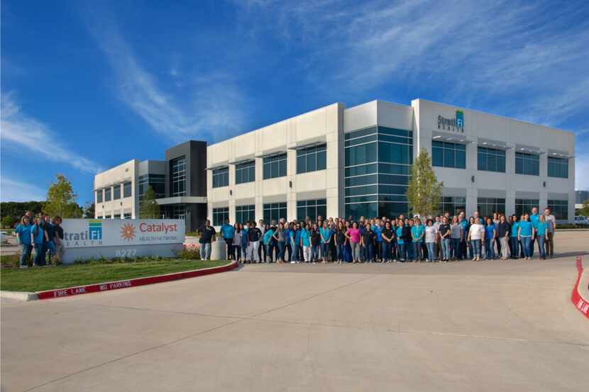 Catalyst Health workers pose for a group shot at its Plano office.