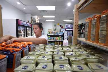 Nayanais Mora stocks the shelves at Latin Market in Plano, TX, on Nov 13, 2023.  (Jason...