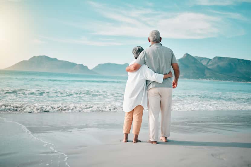 Back, hug or old couple on beach to relax with love, care or support on summer vacation in...