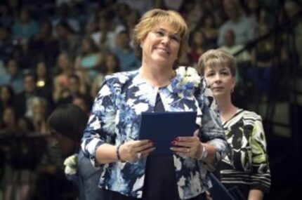  Principal Sylvia Palacios hands out diplomas during the Frisco High School graduation...