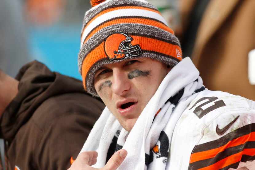 This Dec. 21, 2014 photo, Cleveland Browns' Johnny Manziel (2) sits on the bench during the...
