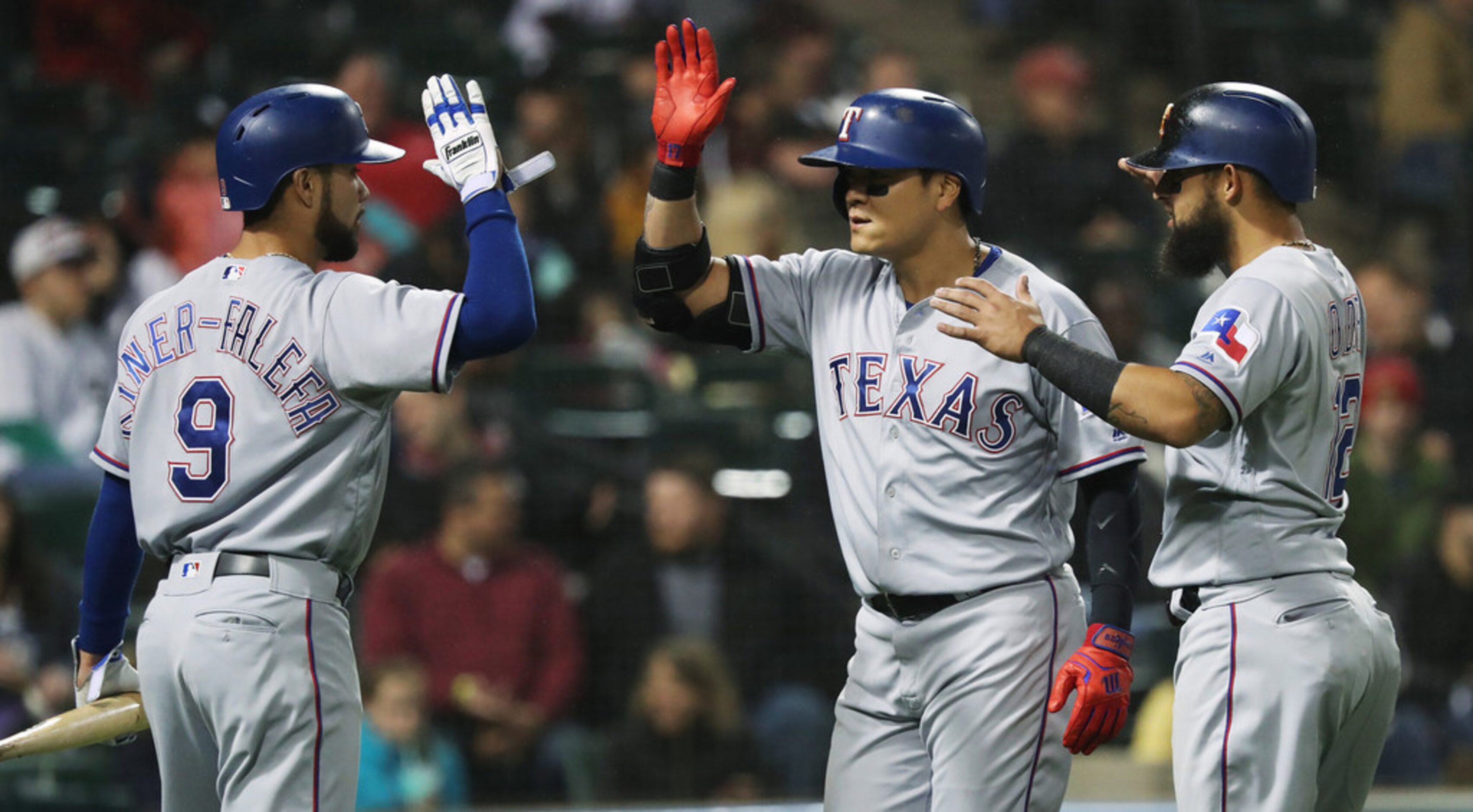 Texas Rangers right fielder Shin-Soo Choo (17), center, is congratulated after hitting a...