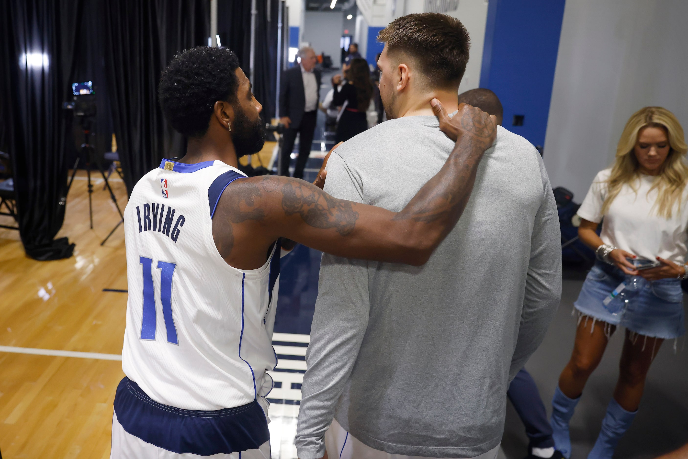 Dallas Mavericks guard Kyrie Irving (11) puts his arm around guard Luka Doncic (77) as the...