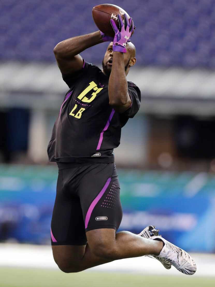 Alabama linebacker Rashaan Evans runs a drill during the NFL football scouting combine,...