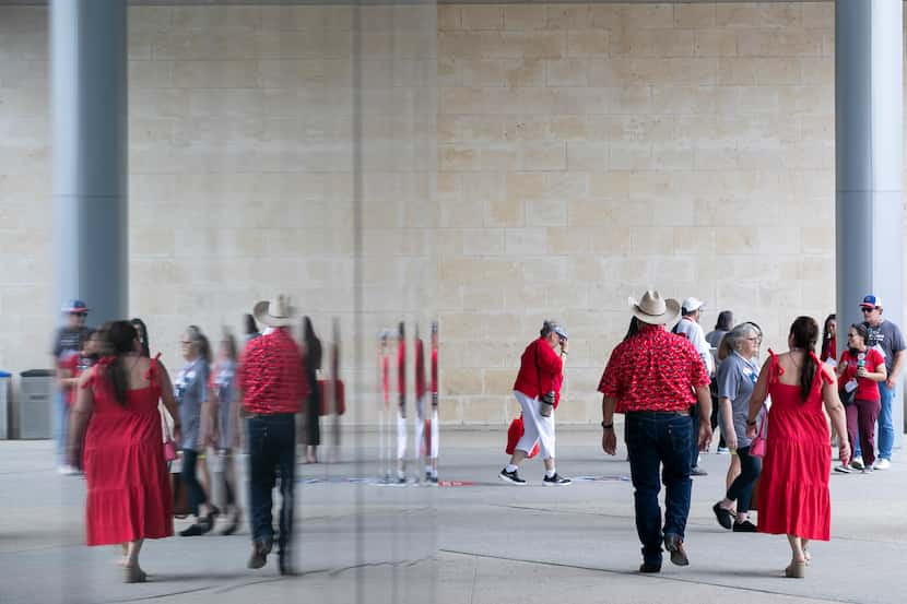 People wearing red are seen leaving and entering the Texas GOP convention at Henry B....